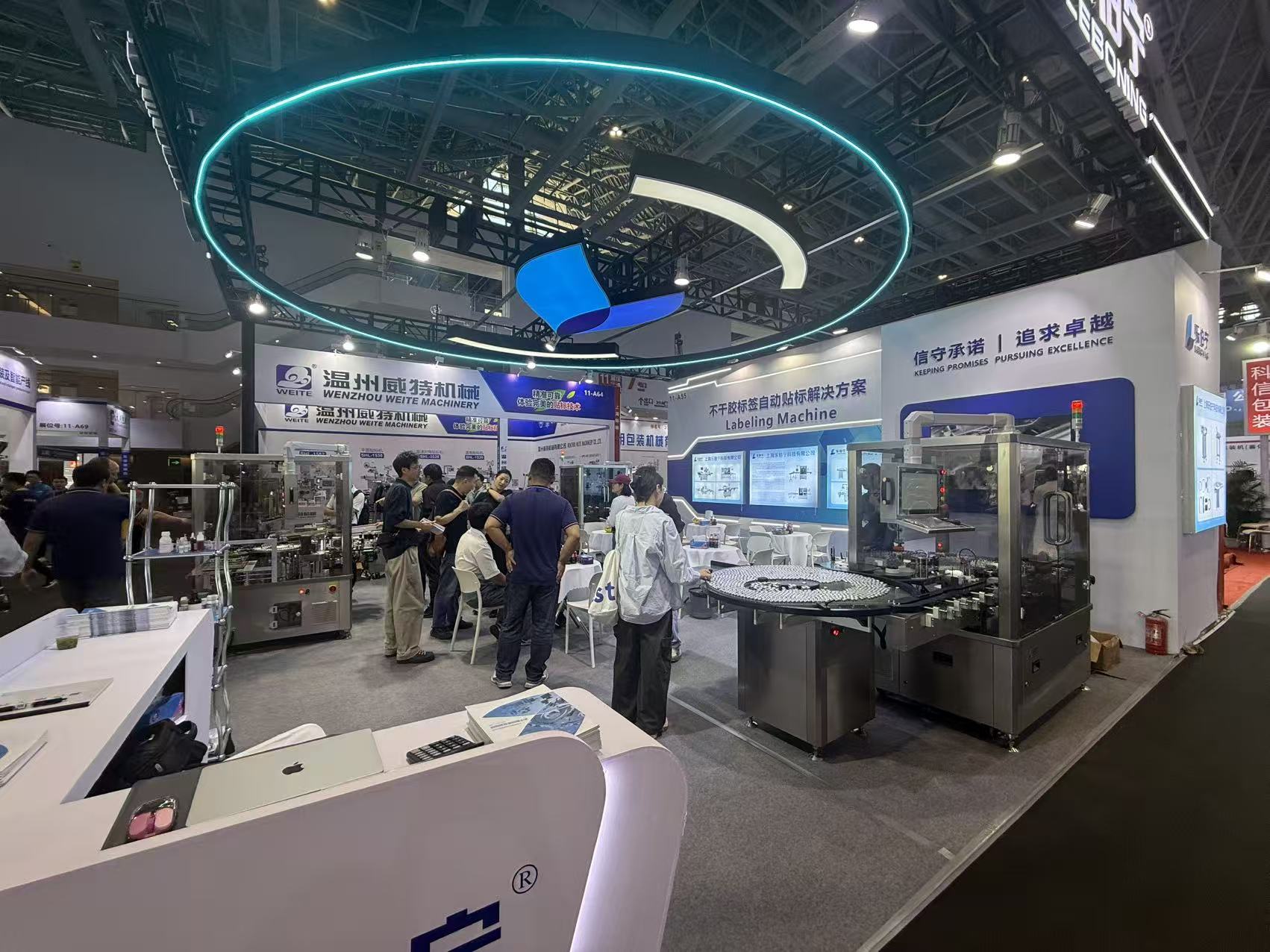 LEBONING exhibition booth with pharmaceutical labeling machines and visitors at CIPM 2026 in Xiamen